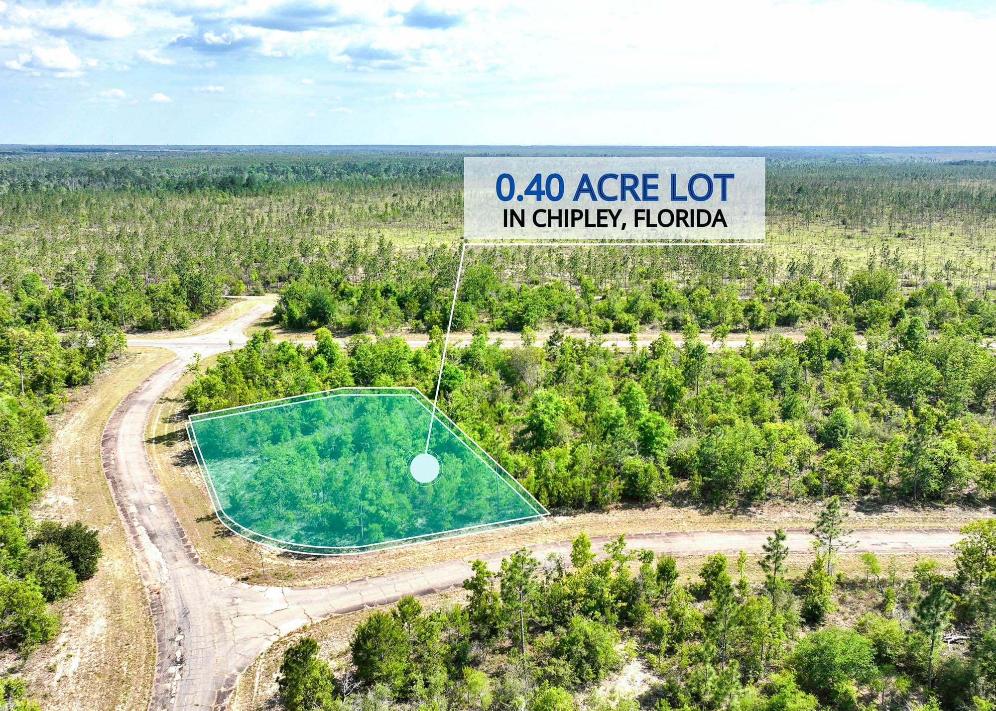 Aerial photo of the northeast corner with the parcel bordered by pines and a gravel road below in Washington County, Florida.