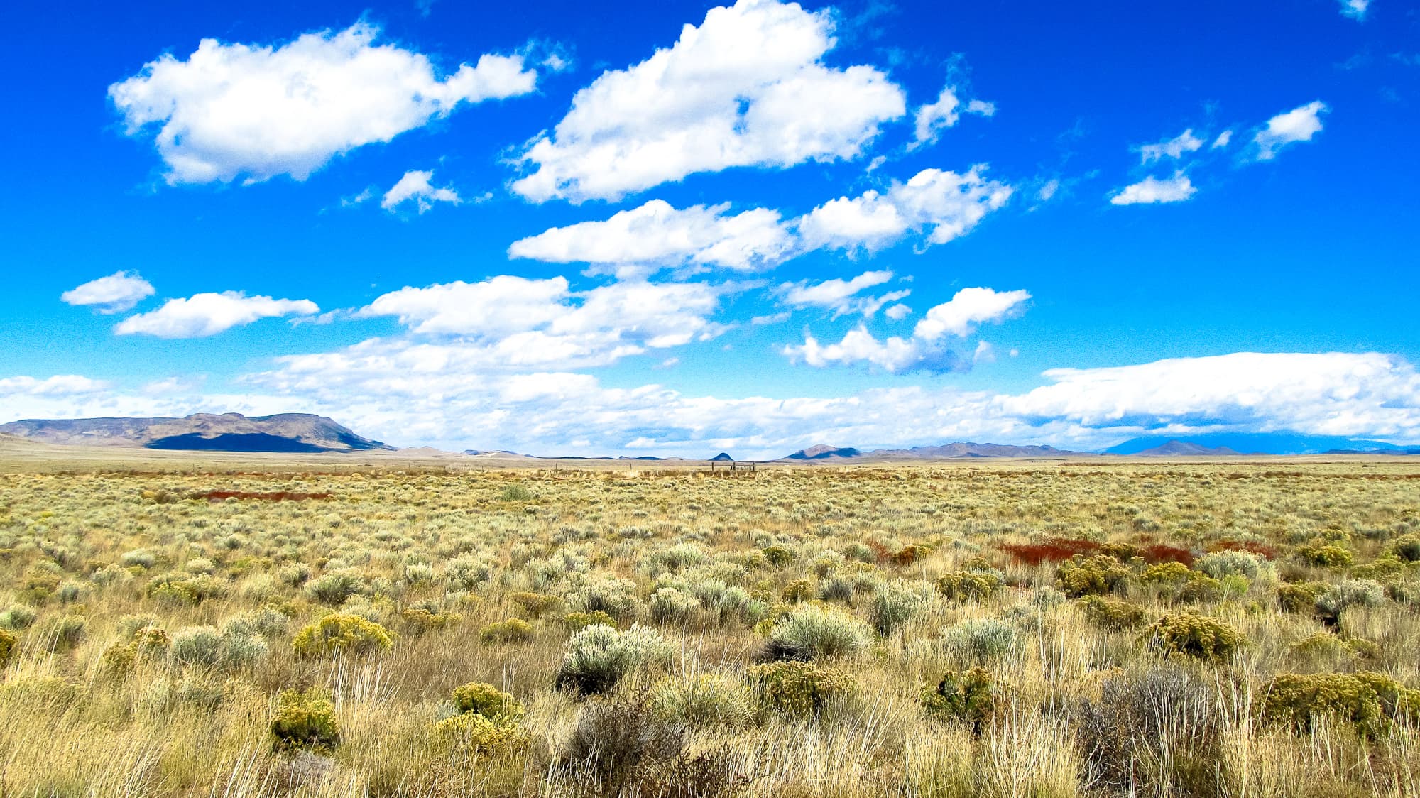Northwest-facing view from the parcel showing scattered sagebrush and distant peaks in Costilla County, Colorado.