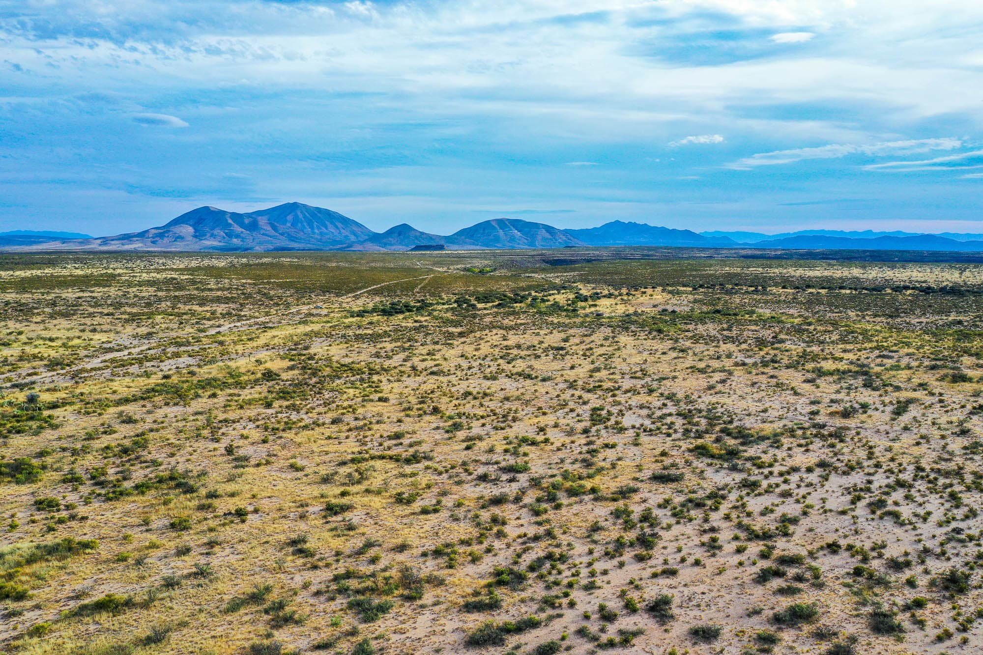 Aerial photo of the entire 53.24-acre property with mountains on the horizon in Texas.