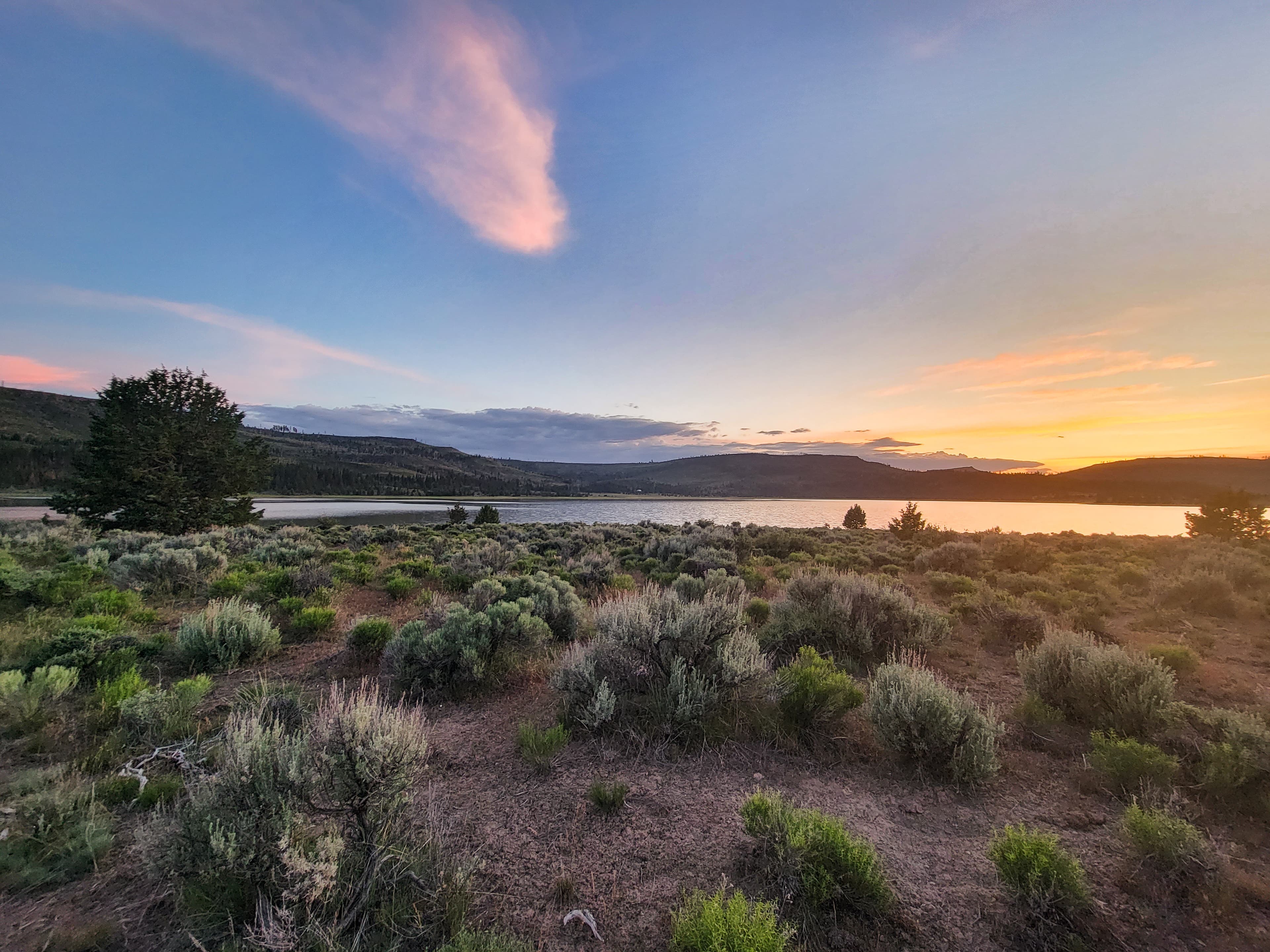 Sage flats and a still lake under a pink sunset